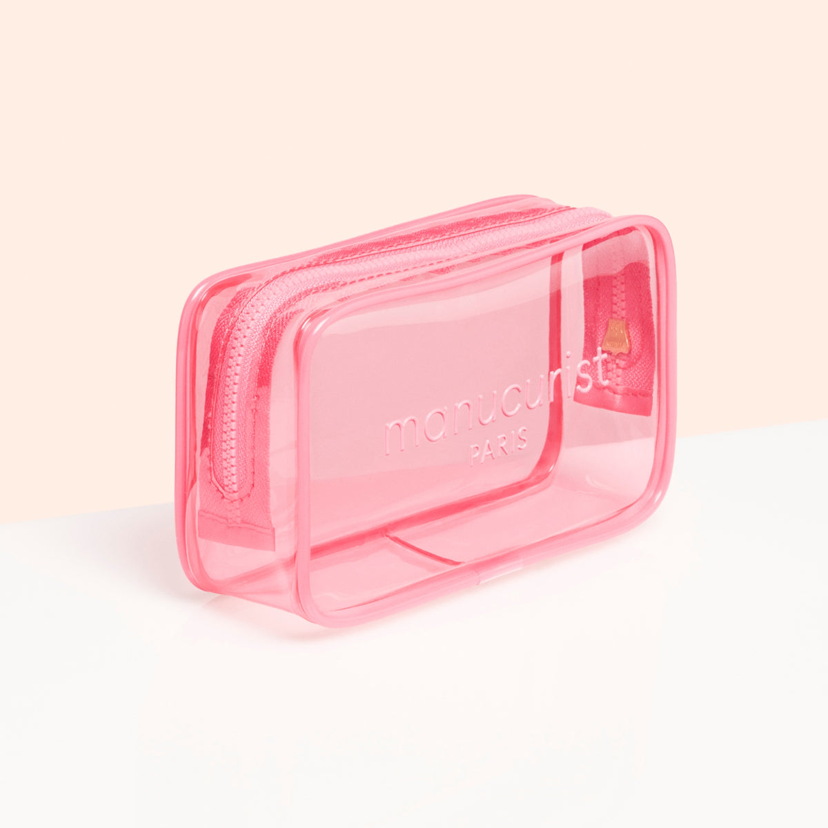 Le Mini Jelly Bag de Manucurist est une petite trousse rectangulaire rose transparente arborant "manucurist PARIS" à l&