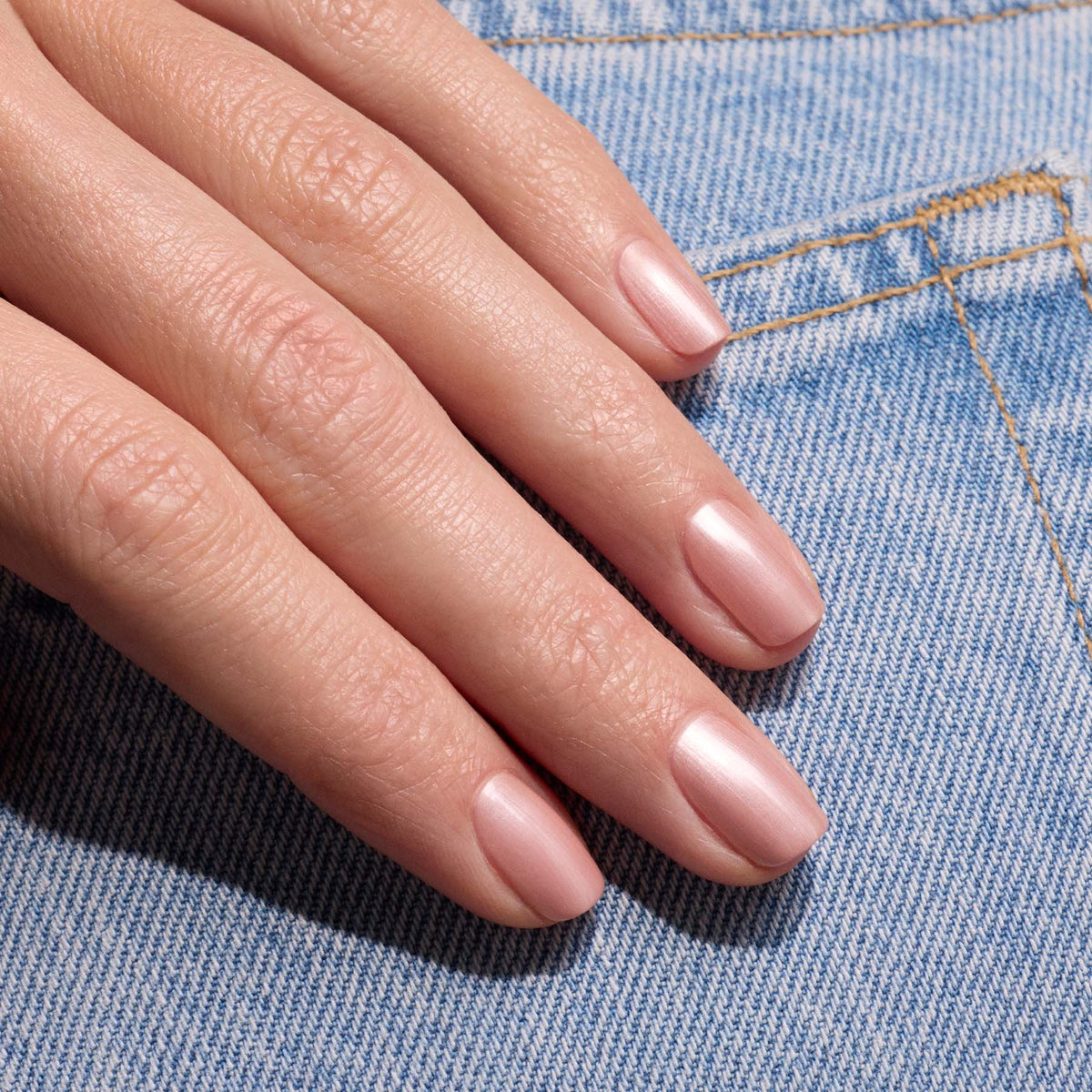 A hand with neatly manicured nails painted in Manucurist&
