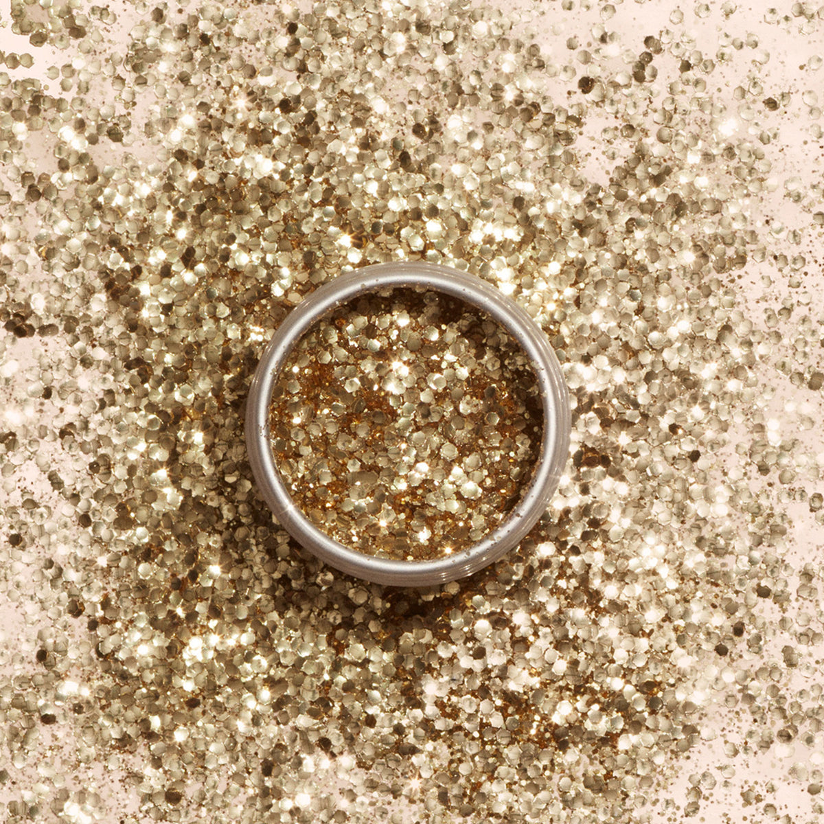 The Manucurist Ready to Party Duo features a silver ring displayed on gold biodegradable glitter, with shimmering accents inside the ring—an ideal holiday gift.
