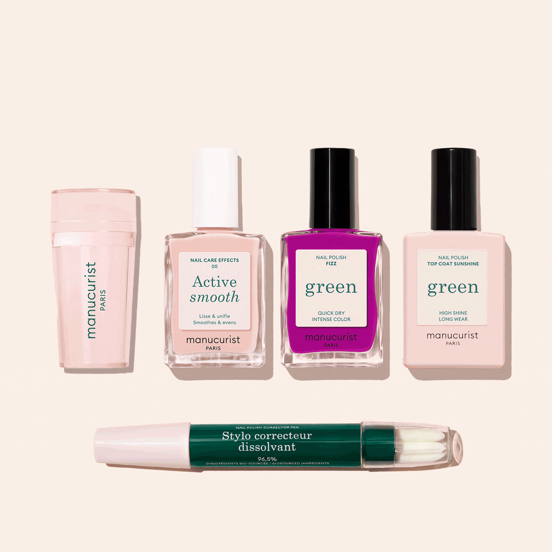 Five Manucurist French Color Kit products are displayed on a light beige background: a nail buffer, two pale pink polishes, one bright fuchsia polish, and a green-capped corrector pen for flawless nails.