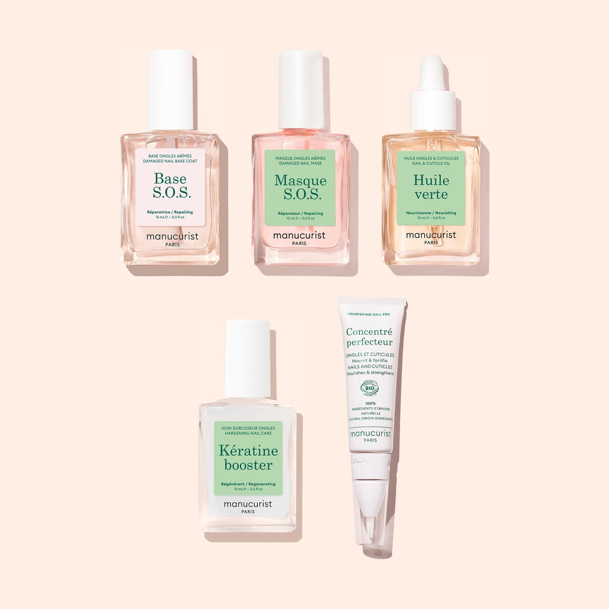 Cinq produits du coffret Routine Découverte - Ongles abîmés de Manucurist — comprenant des flacons transparents et roses à pipette pour l&