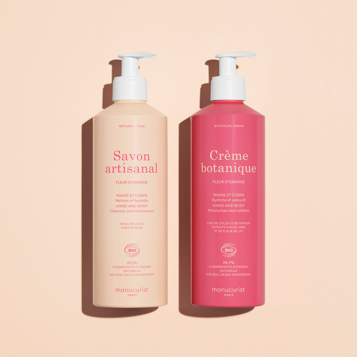 Two Manucurist pump bottles on beige: the light pink is Organic Orange Blossom Hand Body Wash - Cosmos Organic, the dark pink is Crème botanique. Both for hand and body, scented with orange blossom.