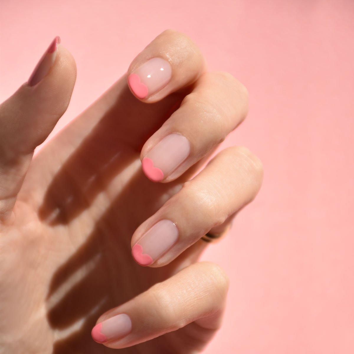 A hand with neatly manicured nails, styled with Manucurist&