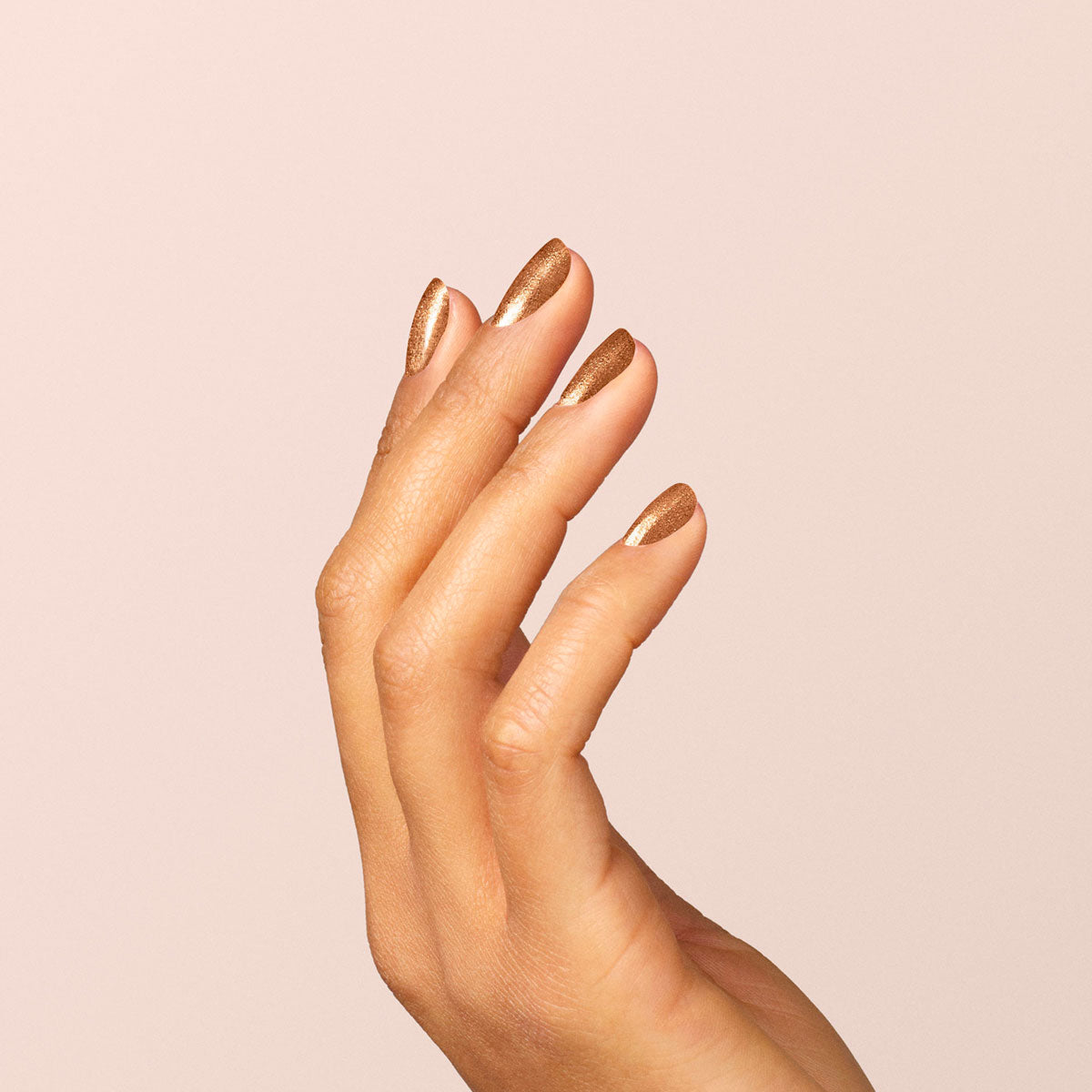 A hand with neatly manicured nails painted in Manucurist&