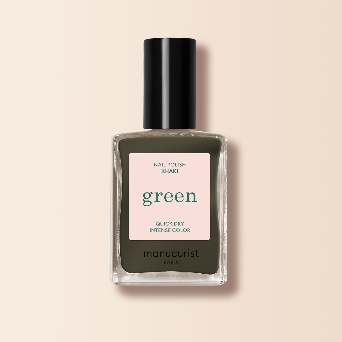 A bottle of Manucurist Khaki nail polish with a black cap, featuring quick-dry and intense color, sits on a light beige background—ideal for a modern manicure with its subtle grey undertone.