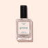 A bottle of Manucurist Tweed nail polish, a soft grey shade with pearly undertones and a black cap, is set against a light pink background.