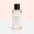 A clear bottle with a black cap contains Manucurist Nail Polish Removing Oil, a green, plant-based formula. The bottle features a light pink label with green text on a beige and white background.