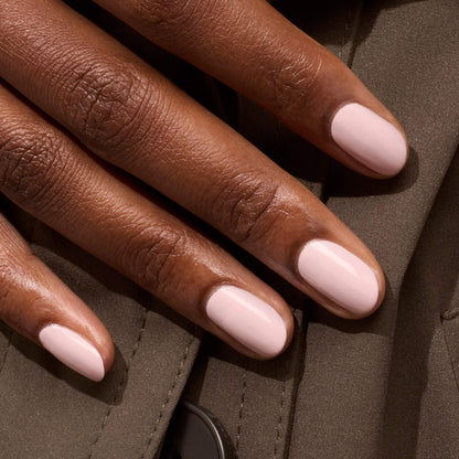 A close-up of a hand with short, manicured nails painted in Manucurist&