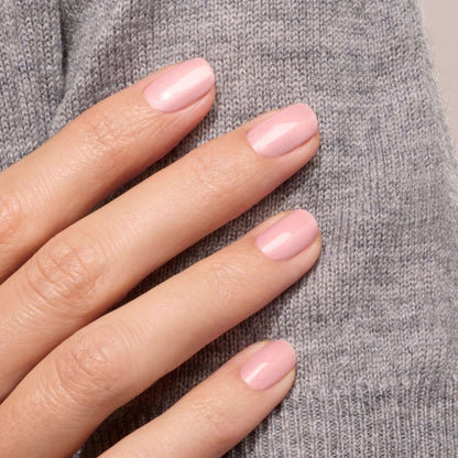 A hand with neatly manicured nails painted in Manucurist&
