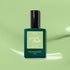 A dark green bottle of Milky Matcha by Manucurist—a creamy, milky matcha green gel polish—rests on a light green background with gentle shadows.