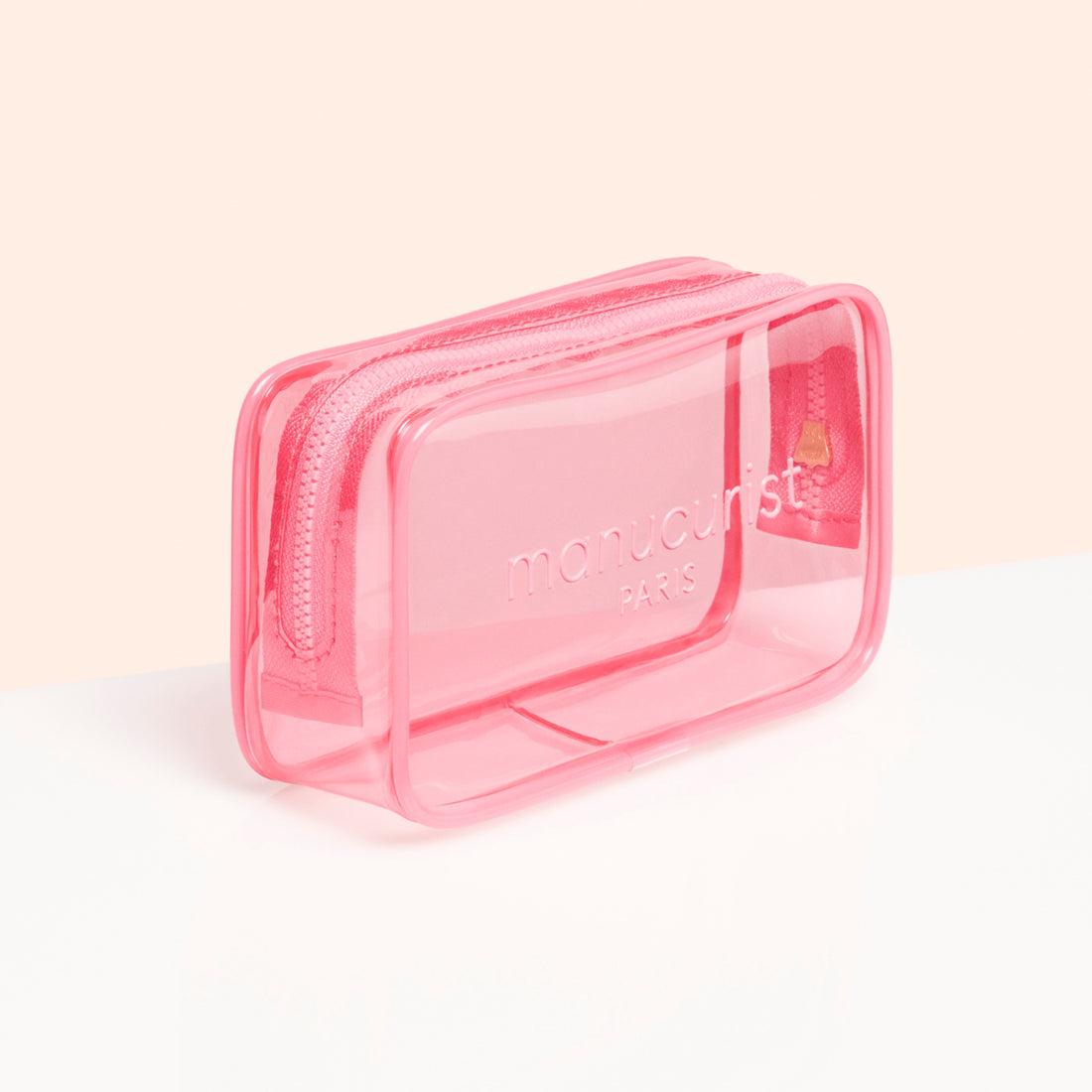 Le Mini Jelly Bag de Manucurist est une petite trousse rectangulaire rose transparente arborant "manucurist PARIS" à l&