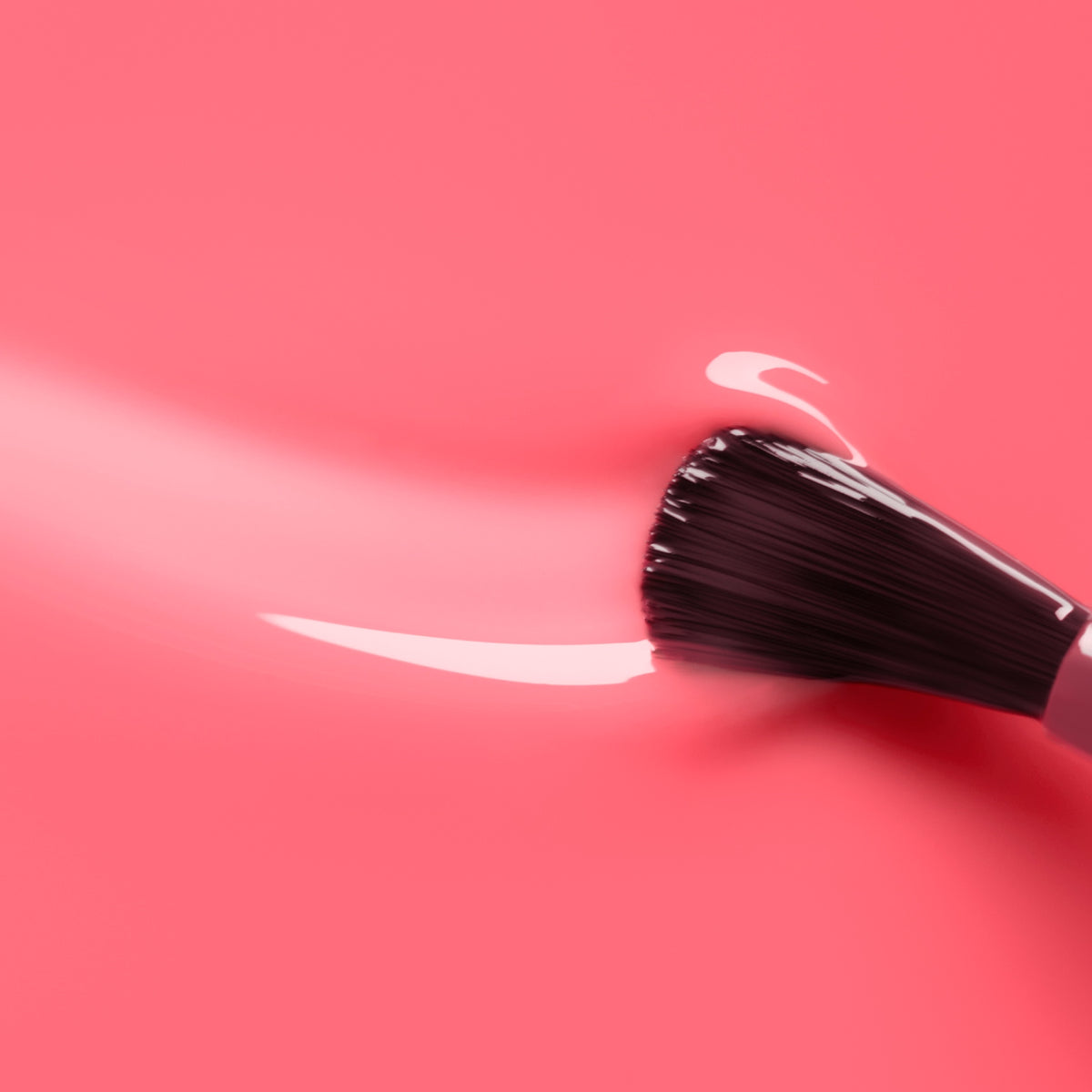 A Manucurist brush glides Sugar Plum Jelly nail polish in glossy pink across a matching surface, leaving a smooth, shiny trail.