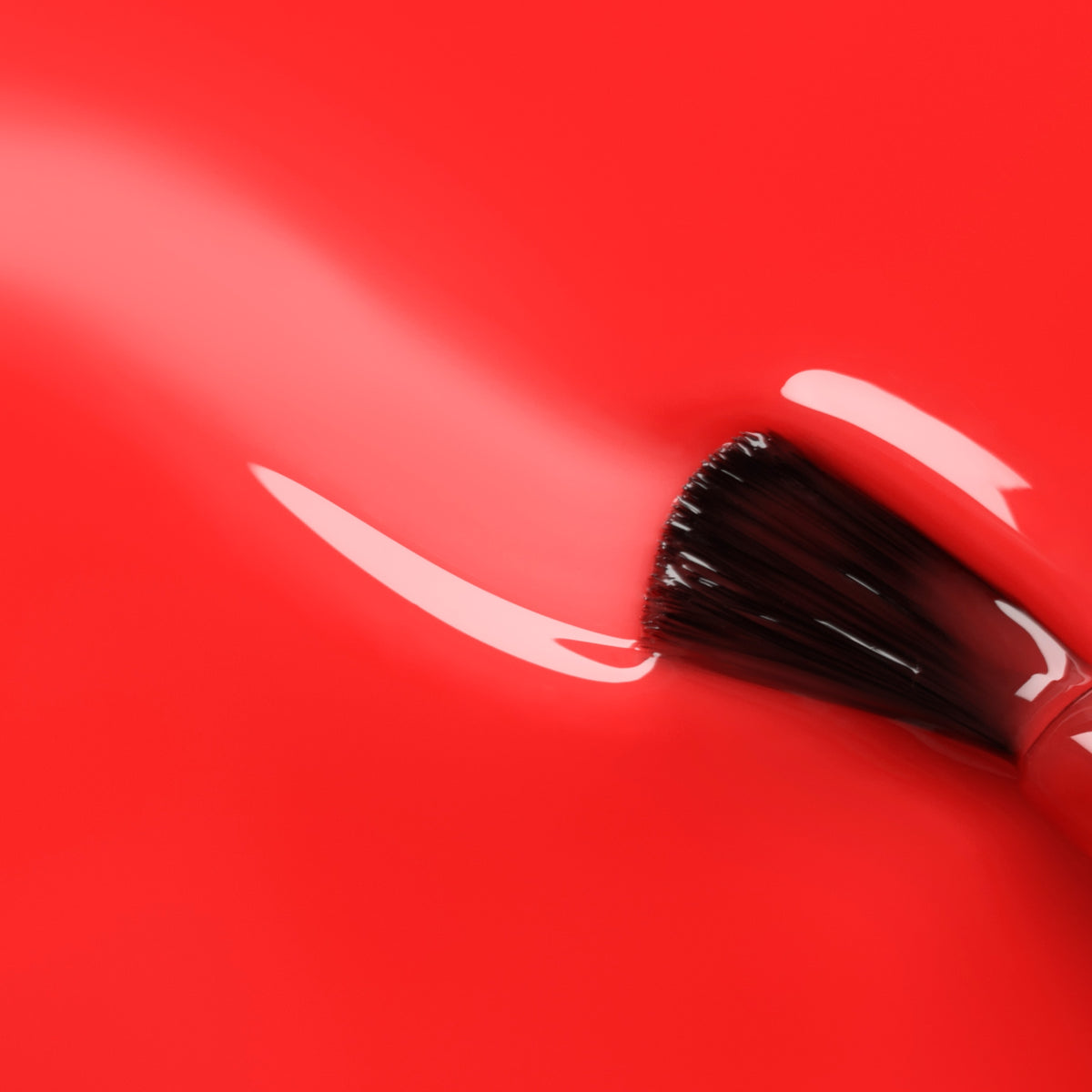 A close-up of a makeup brush applying Manucurist&