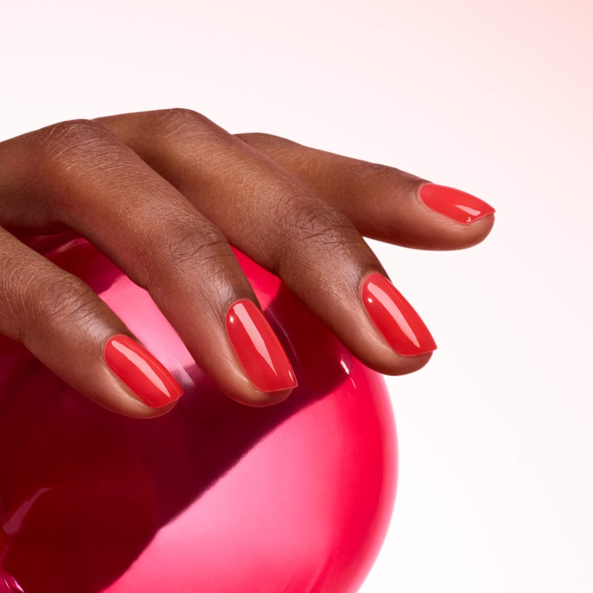 A hand with neatly manicured nails painted in Manucurist&
