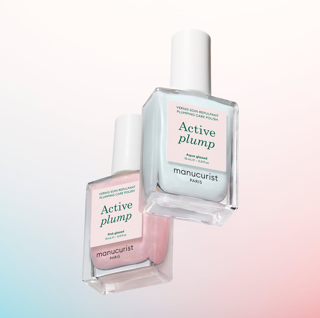Two bottles of Manucurist Paris Active Plump nail polish are shown: one pale pink labeled Pink Glaze and one pale blue labeled Aqua Glazed, both on a pastel gradient background.