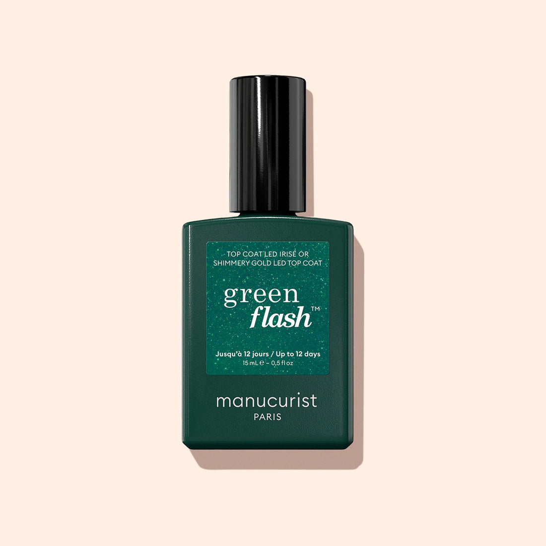 A dark green bottle of Manucurist Glitter Top Coat nail polish with a black cap is shown against a light beige background, offering long-lasting shine for your manicure.
