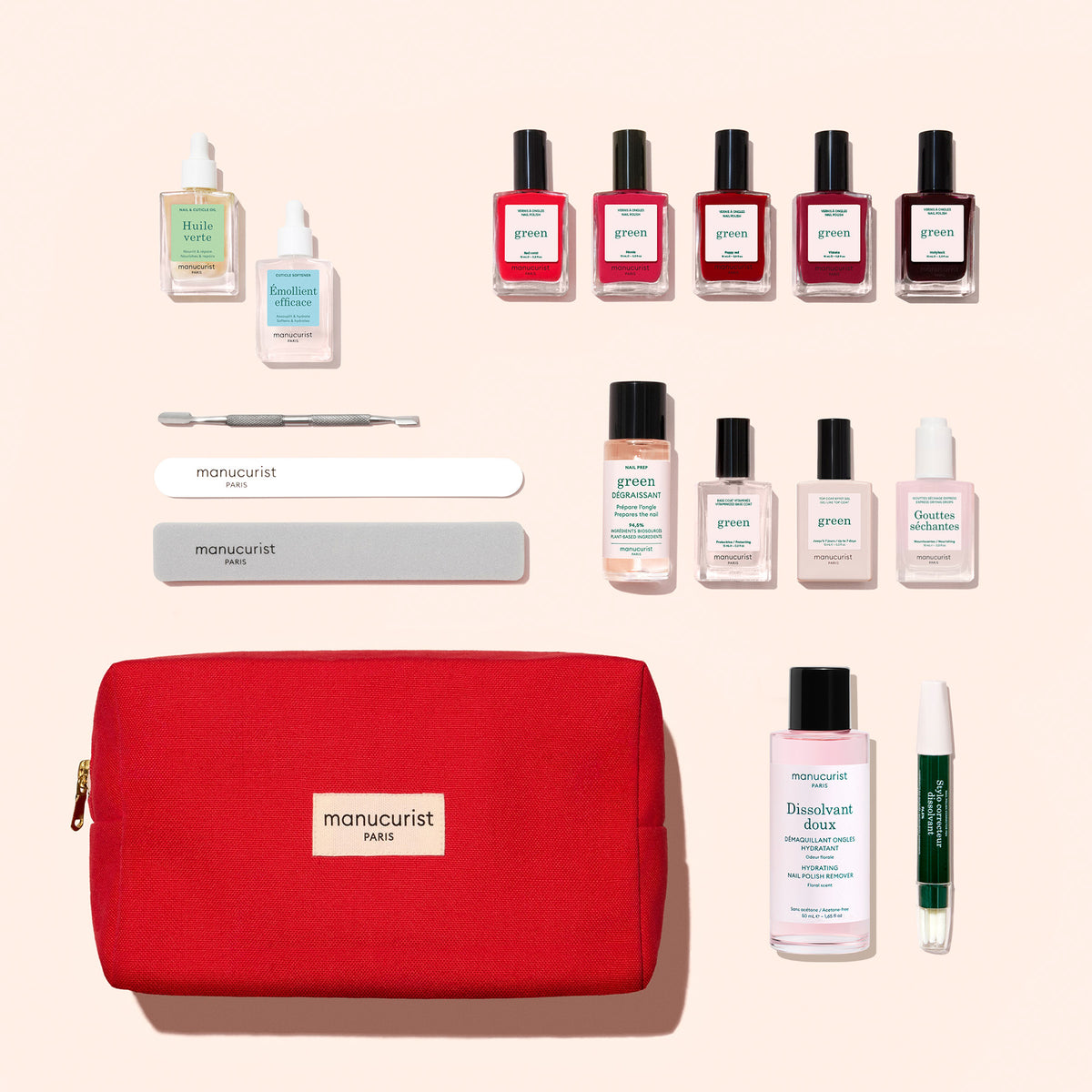 A red Manucurist pouch from the Super Ultimate Kit, featuring nail care tools, a vitaminized base coat, gel-effect nail polish in assorted colors, removers, and other care products, all arranged neatly on a light background.