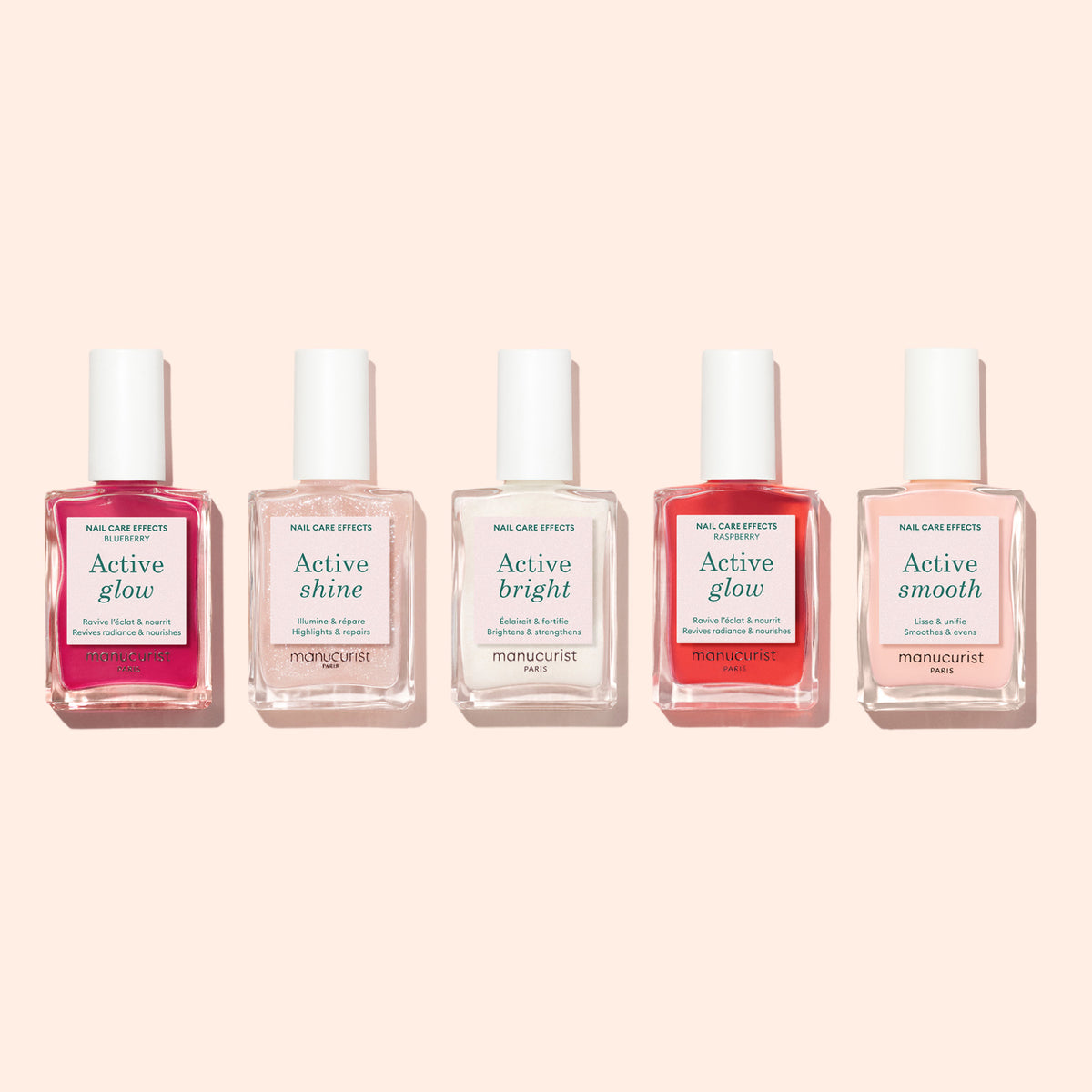 Cinq flacons du kit Welcome Manucurist-test Active 5-pack sont alignés sur un fond pêche clair, chacun portant une étiquette indiquant les effets : Active Glow, Active Shine, Active Bright, Active Glow et Active Smooth.