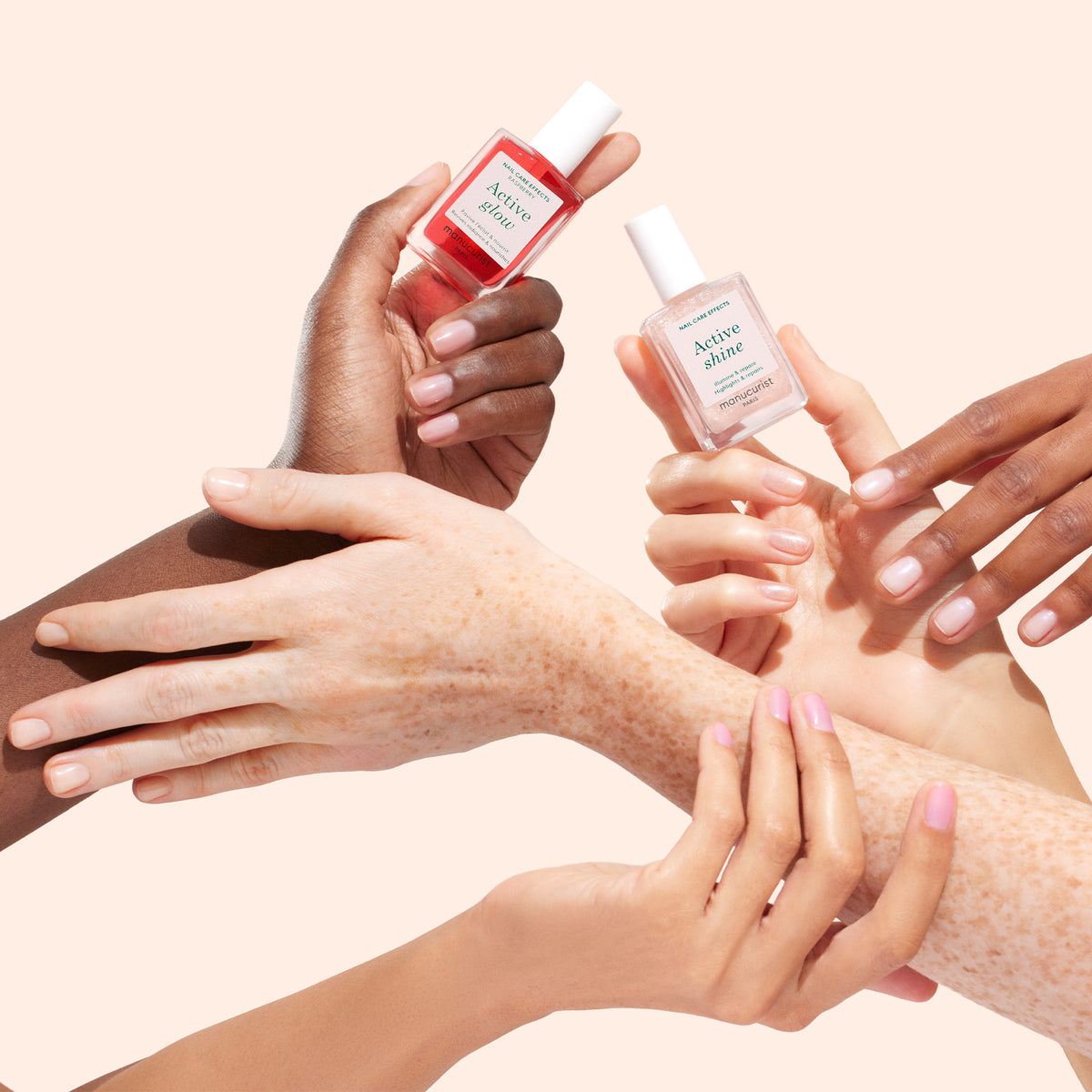 Several hands with different skin tones display manicured nails and hold two bottles of Active Shine nail polish—one pink and one clear—against a light beige background.