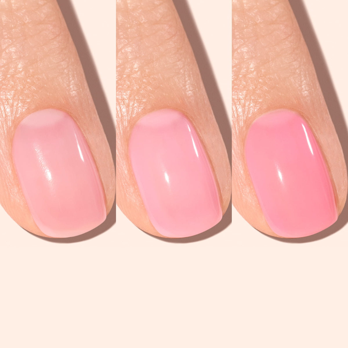Three fingers with gradually intensifying pink nail polish from left to right, showing a transition from a light sheer pink to a more opaque, vibrant pink shade under soft lighting.