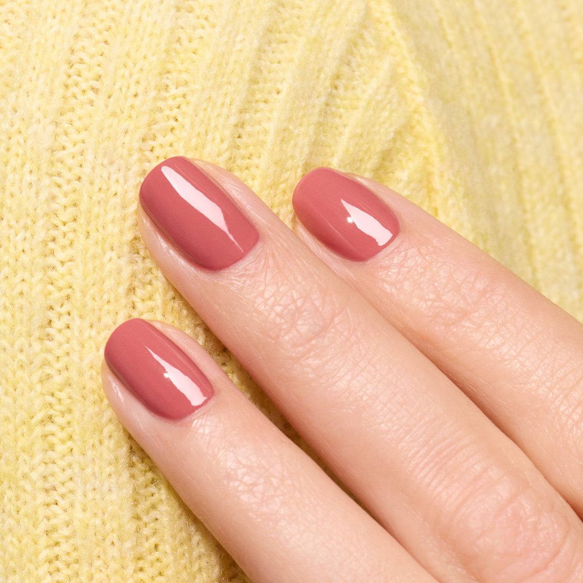 A close-up of a hand with neatly manicured nails painted in Manucurist&