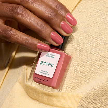 A hand with short, oval nails painted in Manucurist&