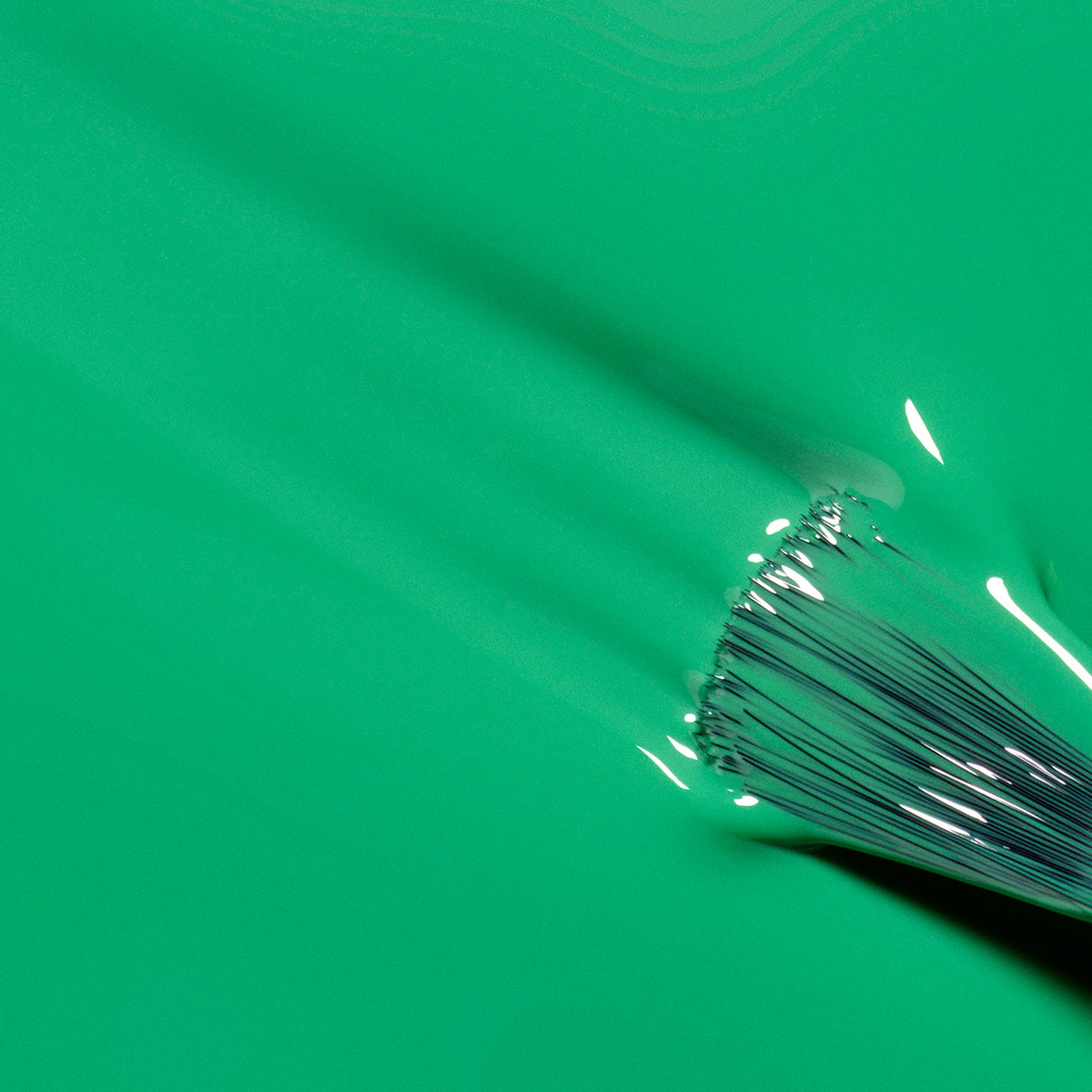 A close-up of a paintbrush applying Manucurist&