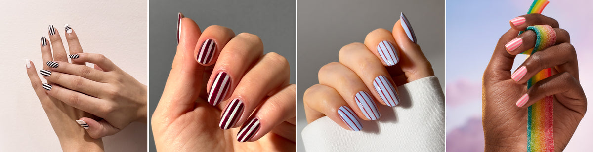 Four hands with manicured nails, each featuring striped nail art in different colors: black and white, black and pink, blue and white, and pink with rainbow stripes, against various backgrounds.