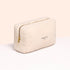 A cream-colored, textured zippered pouch with "Manucurist PARIS" in gold, ideal for carrying your Customizable 5-pack nail polish set by Manucurist, shown against a light neutral background.
