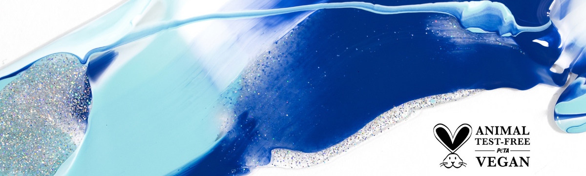 Abstract swirls of blue, light blue, and white paint with silver glitter on a white background. In the lower right corner, a PETA Animal Test-Free  Vegan certification logo is visible.