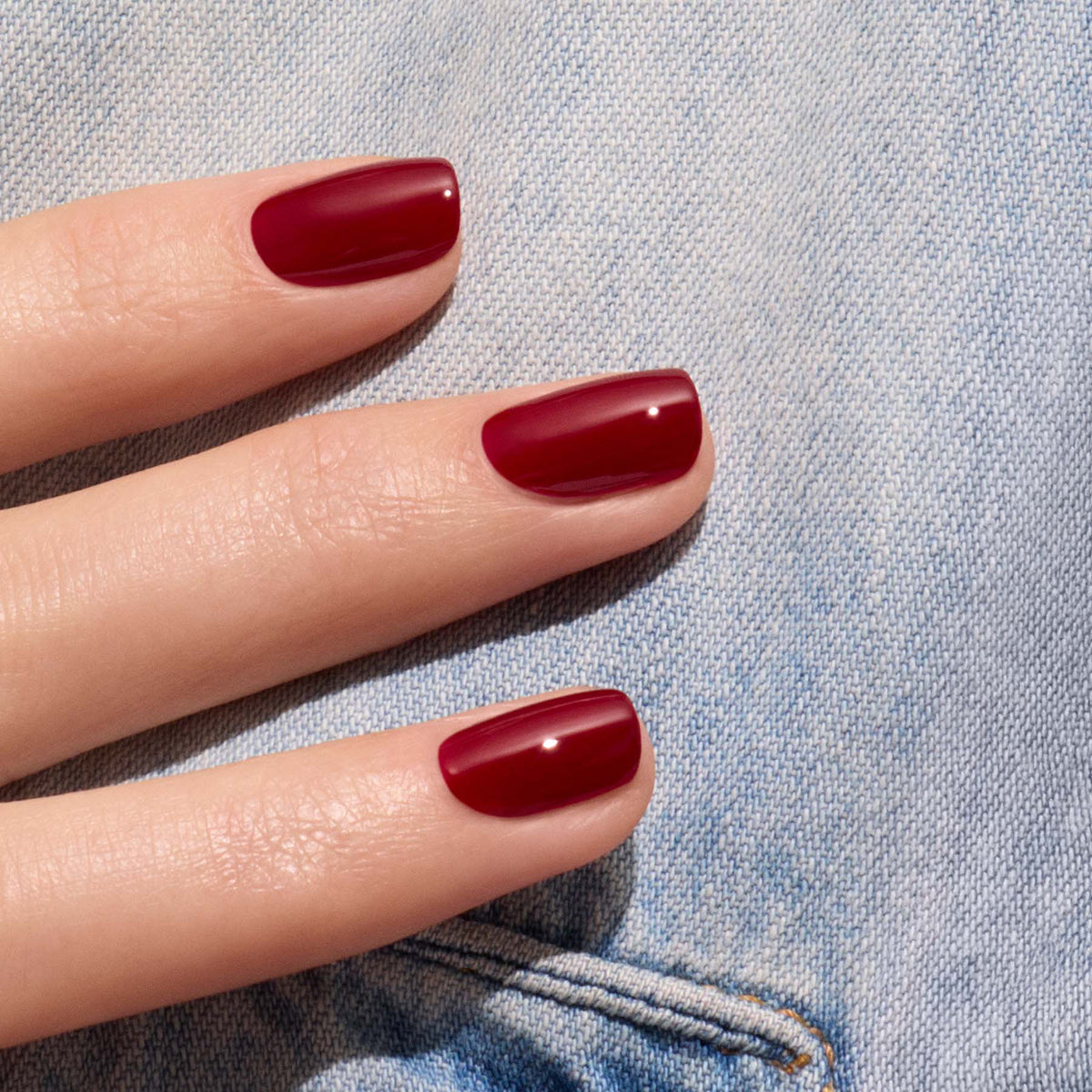 A hand with neatly manicured nails painted in Manucurist&