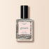 A clear glass bottle of Manucurist Disco silver glitter nail polish from the Green™ range, labeled green and quick dry intense color, stands upright against a light beige background.