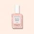 A bottle of Manucurist Active™ Shine Opal plant-based nail polish, featuring a white cap and filled with a light pink, shimmery formula designed to strengthen nails, displayed against a pale beige background.