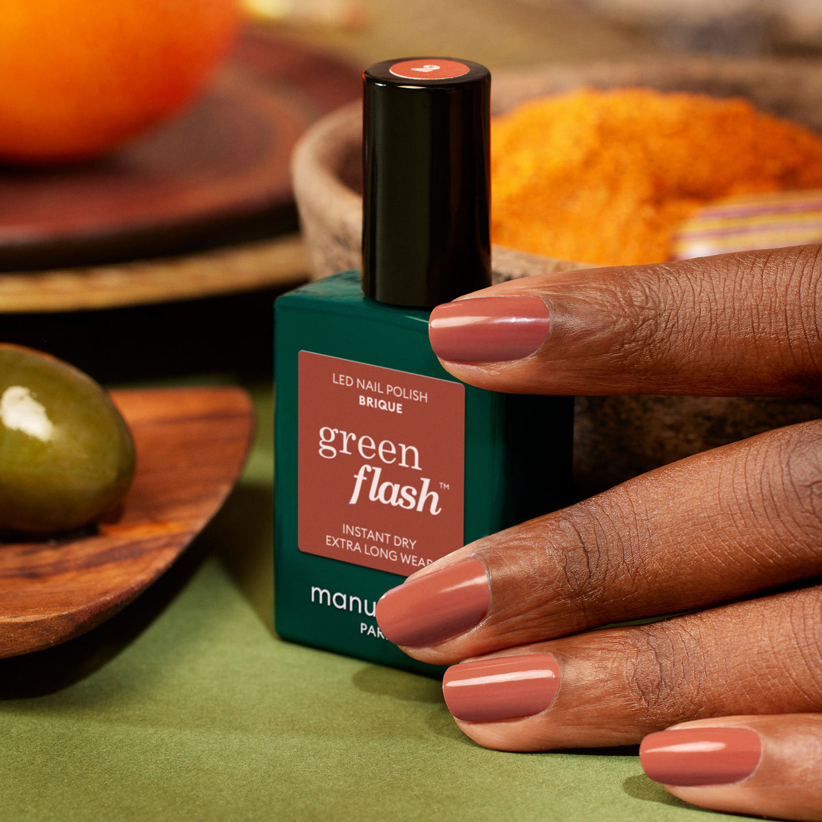 A hand with neatly manicured nails painted in Manucurist&