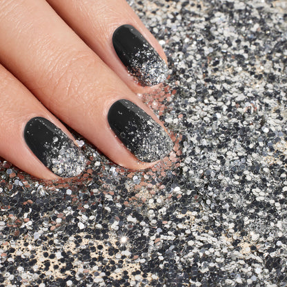 A hand with black and silver ombré nails, enhanced by Manucurist&