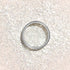 Manucurist Pearlescent Glitter Flakes, a fine white glitter in a round open container, sits amid sparkling flakes to create a shimmering effect—perfect for adding brilliance to your next manicure.