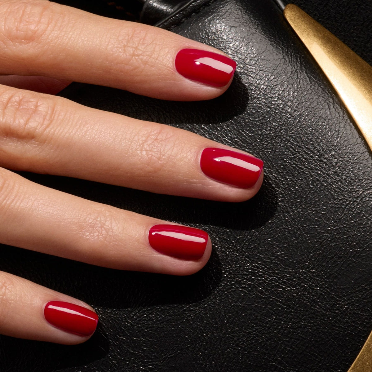 A hand with neatly manicured nails painted in Manucurist&
