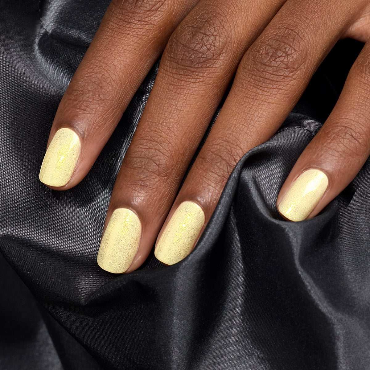 A hand with neatly manicured nails painted in Manucurist&