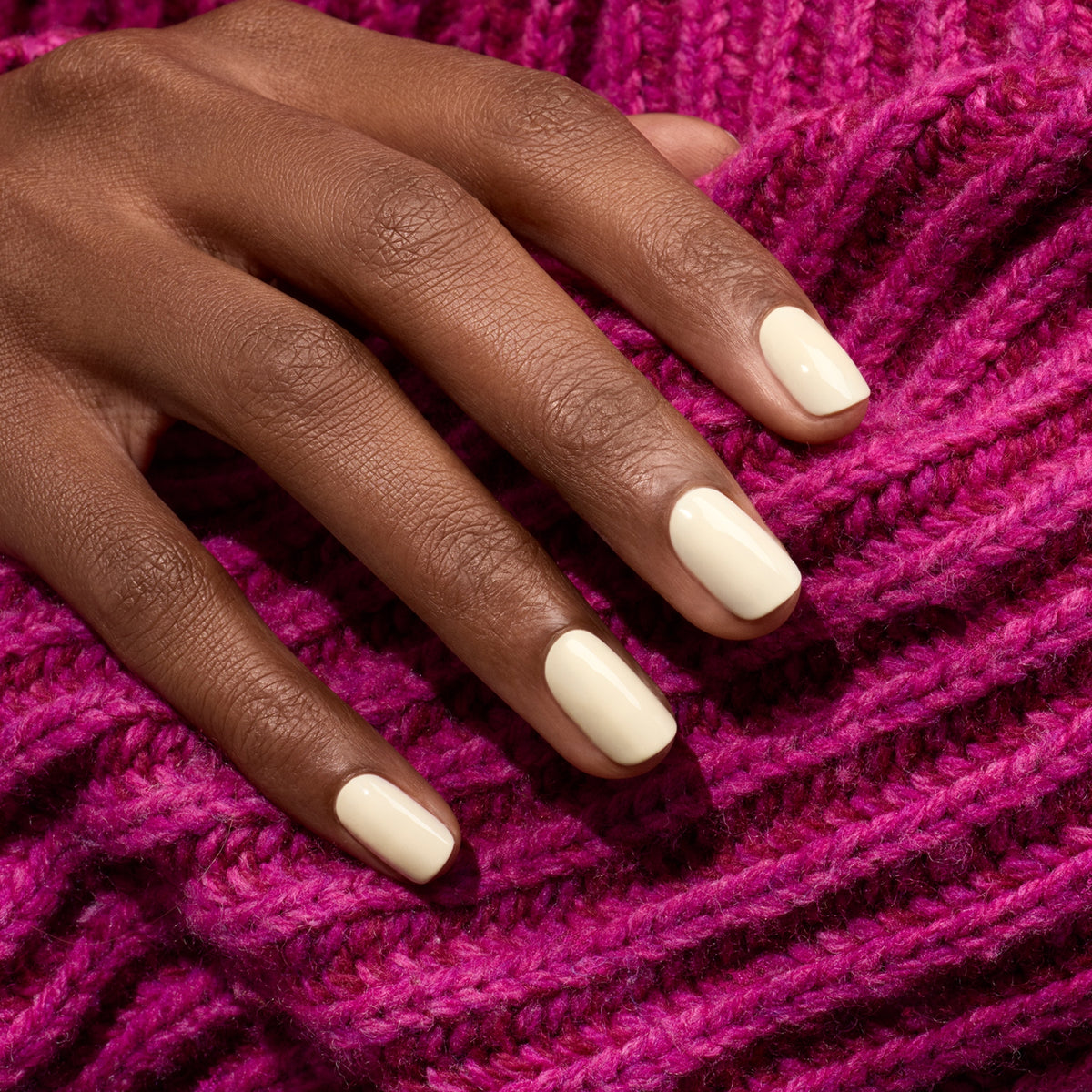 A hand with neatly manicured nails painted in Manucurist&