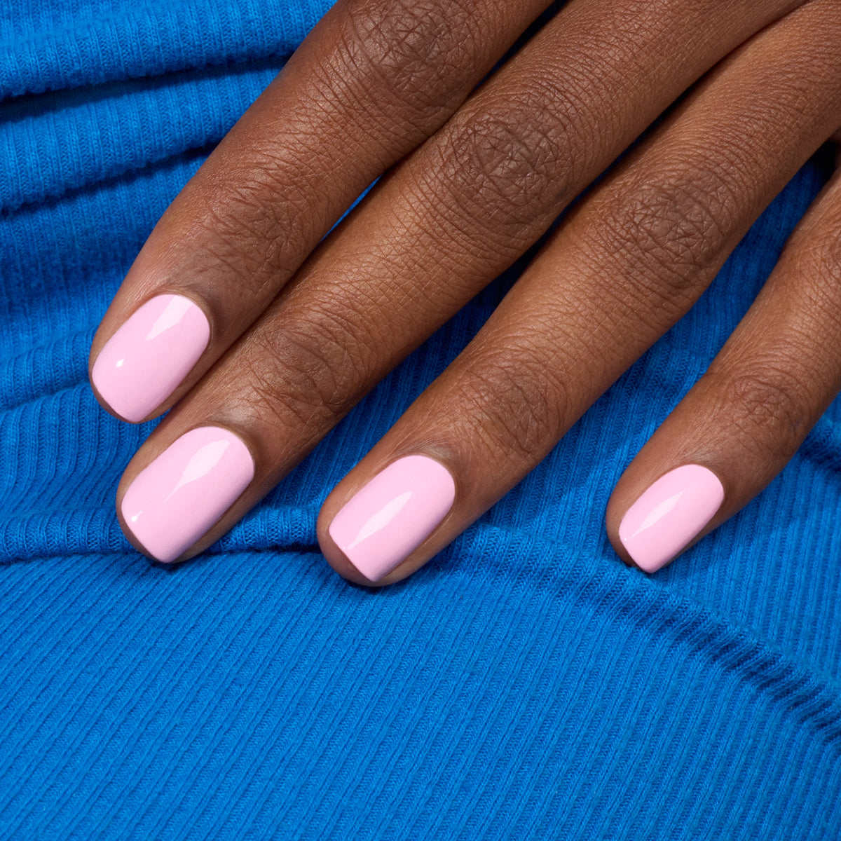A hand with neatly manicured nails painted in Manucurist&
