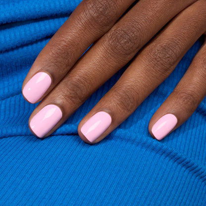 A hand with neatly manicured nails painted in Manucurist&