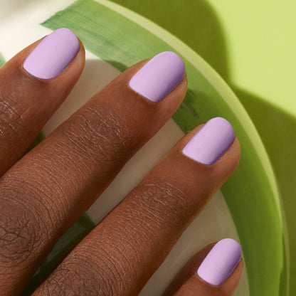 A close-up of a dark-skinned hand with neatly manicured nails painted in Manucurist&