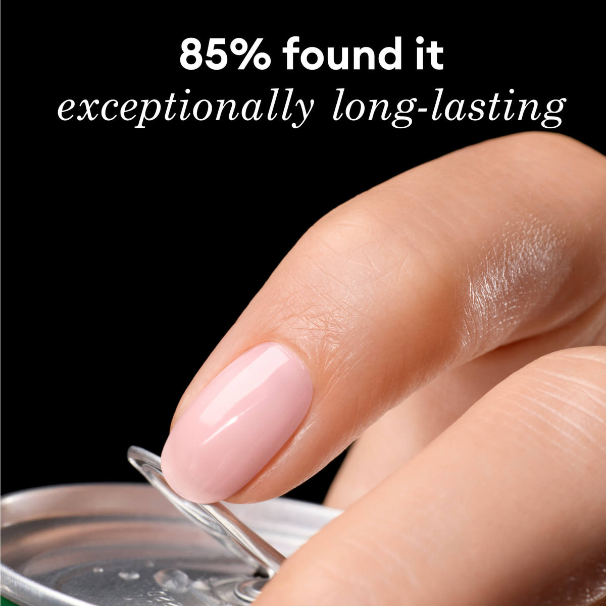 A close-up of a hand with shiny, light pink manicured nails opening a can, with text above reading 85% found it exceptionally long-lasting on a black background.