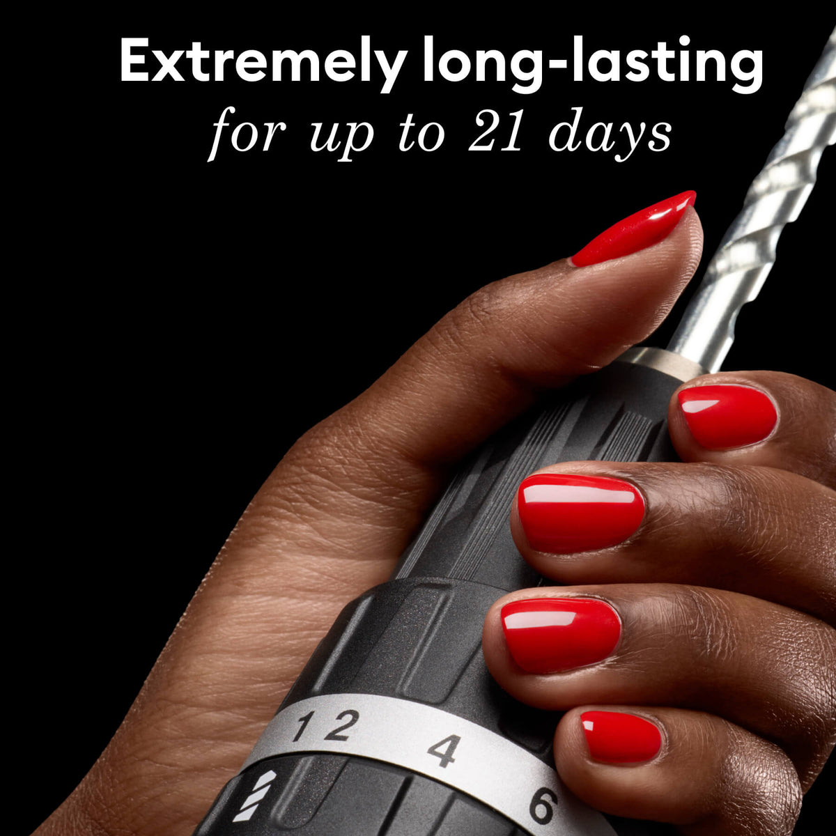 A hand with glossy red nail polish holds a black power drill, with text above that reads, Extremely long-lasting for up to 21 days.