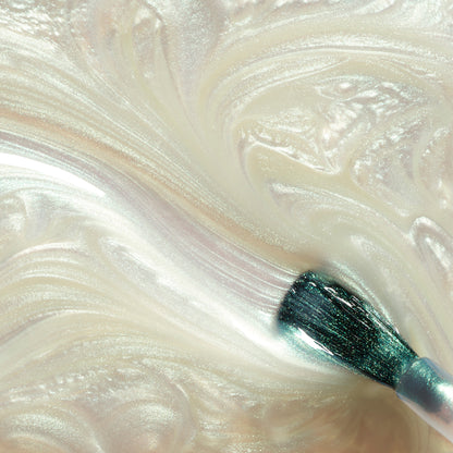 A close-up of a makeup brush swirling through Manucurist&