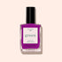 A bottle of Manucurist Fizz nail polish in vibrant purple with magenta undertones, labeled green with “Quick Dry Intense Color” on the front, is shown against a light beige background.
