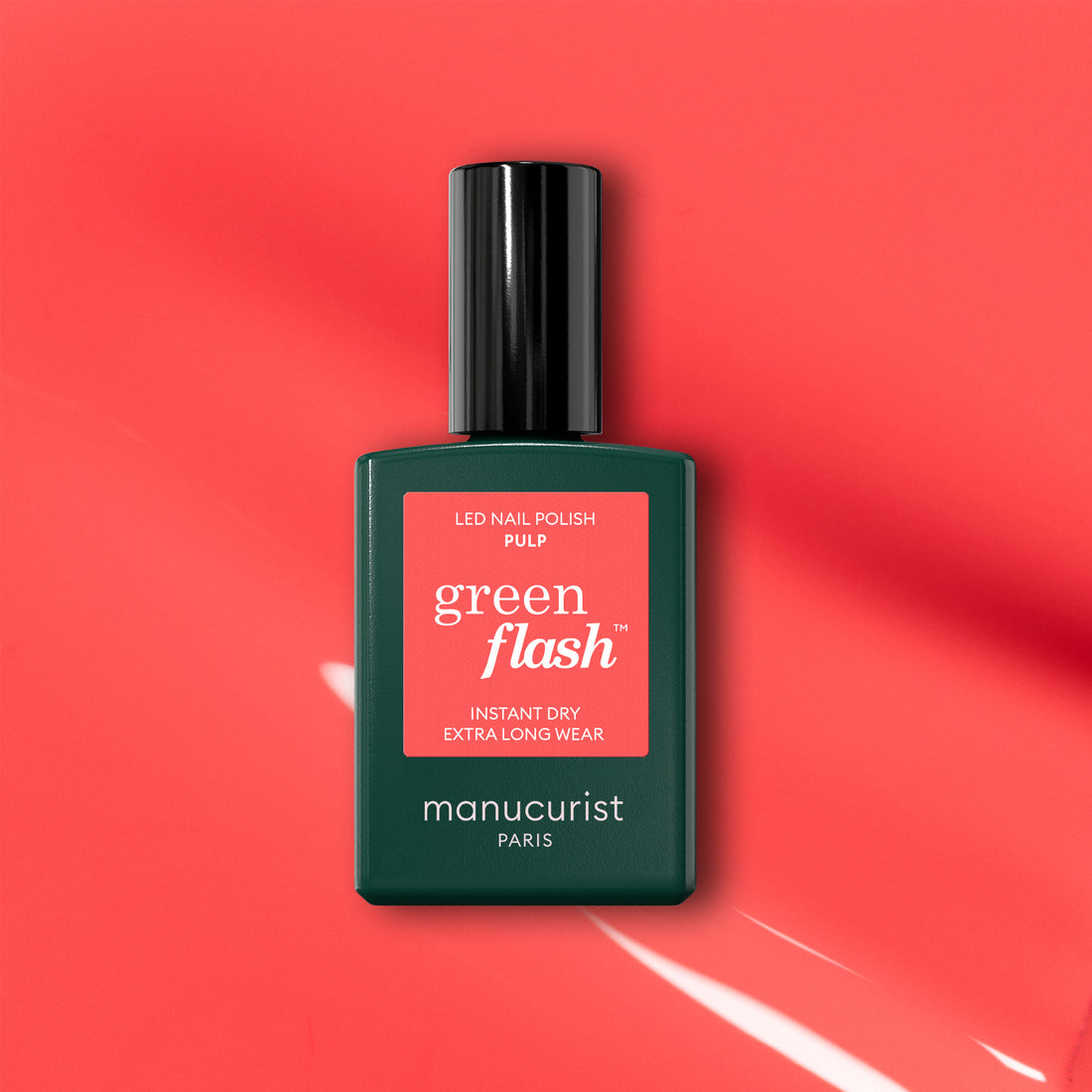 A bottle of Manucurist Pulp gel polish is displayed on a coral pink background with light reflections. The label reads "Pulp, Instant Dry, Extra Long Wear.