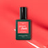 A bottle of Manucurist Pulp gel polish is displayed on a coral pink background with light reflections. The label reads "Pulp, Instant Dry, Extra Long Wear.