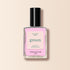 A bottle of Manucurist Candy nail polish with a black cap and a pink label sits against a soft light beige background.