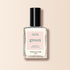Un flacon en verre transparent de vernis à ongles Porcelaine Manucurist au bouchon noir, avec la mention "Quick Dry Intense Color", est présenté sur un fond beige clair.